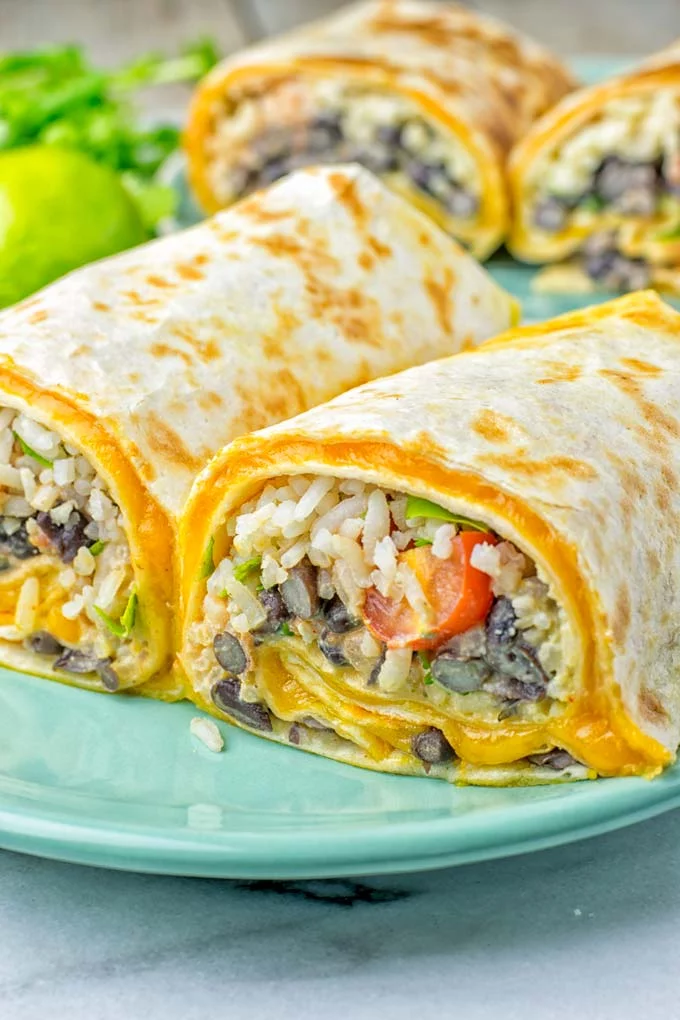 This Rice and Beans Quesarito is entirelly vegan, gluten free and so easy to make. It’s cheesy, incredibly satisfying and so delicious for dinner, lunch, meal prep (reheat beautifully) and amazing for work lunches. An amazing dairy free alternative for everyone that the whole family will love. #vegan #glutenfree #dairyfree #vegetarian #contentednesscooking #quesarito #riceandbeans #dinner #lunch #worklunchideas #mealprep #quesadila #burrito 