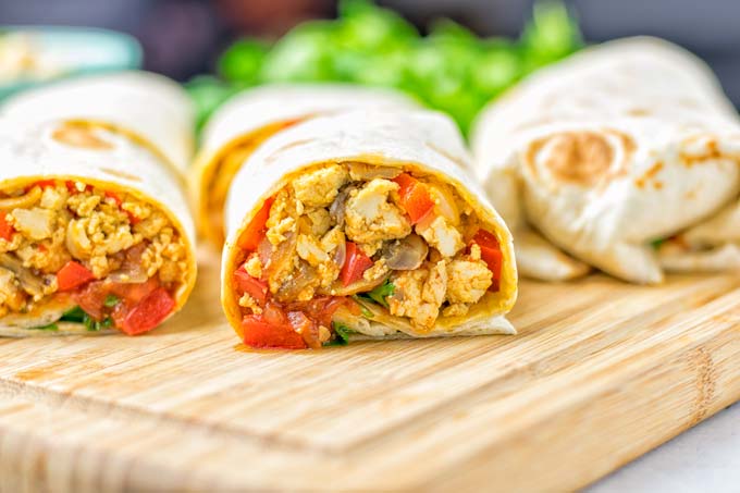 This Vegan Breakfast Burrito with Tofu Scramble is super easy to make and seriously the best burritos you’ve ever made and tasted. No one would guess it’s entirely vegan, gluten free and your family won’t miss the cheese or meat in these. These are also an amazing pick for meal prep, dinner, lunch, work lunch and so much more. #vegan #dairyfree #glutenfree #contentednesscooking #breakfastburritos #tofuscramble #breakfastideas #budgetmeals #dinner #lunch #mealprep #worklunchideas 