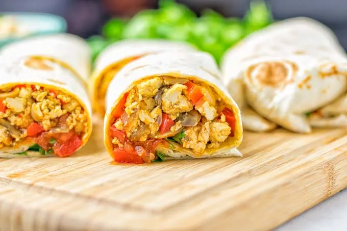 This Vegan Breakfast Burrito with Tofu Scramble is super easy to make and seriously the best burritos you’ve ever made and tasted. No one would guess it’s entirely vegan, gluten free and your family won’t miss the cheese or meat in these. These are also an amazing pick for meal prep, dinner, lunch, work lunch and so much more. #vegan #dairyfree #glutenfree #contentednesscooking #breakfastburritos #tofuscramble #breakfastideas #budgetmeals #dinner #lunch #mealprep #worklunchideas 