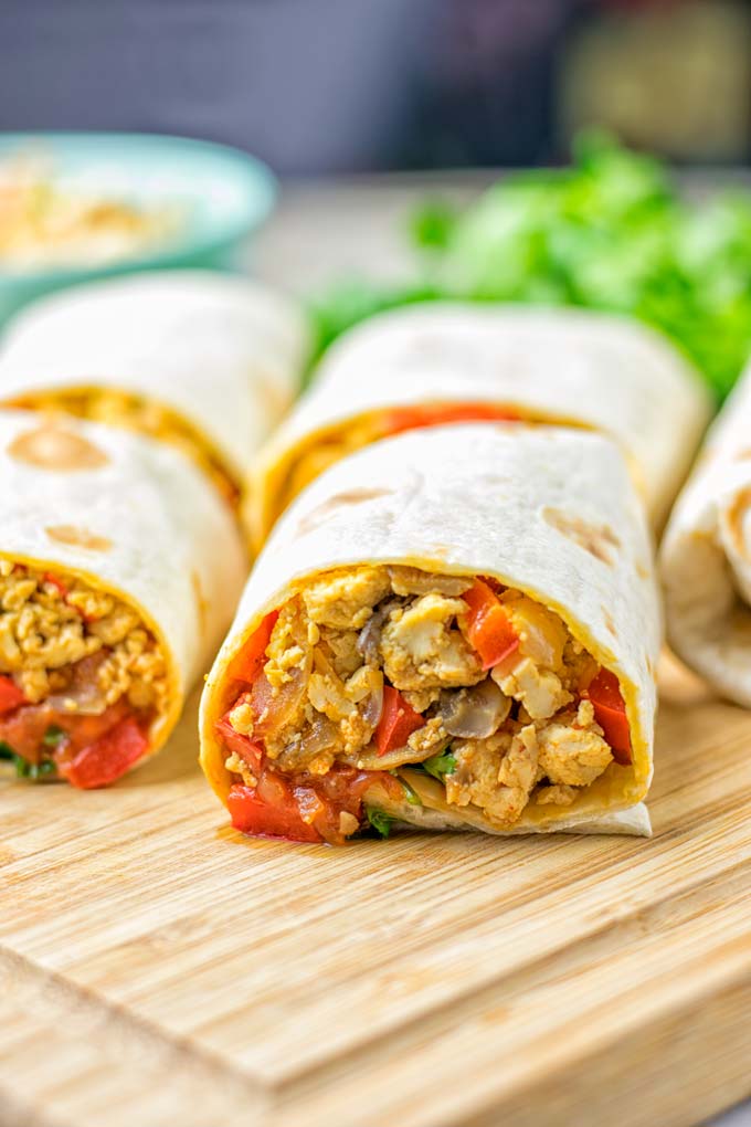 This Vegan Breakfast Burrito with Tofu Scramble is super easy to make and seriously the best burritos you’ve ever made and tasted. No one would guess it’s entirely vegan, gluten free and your family won’t miss the cheese or meat in these. These are also an amazing pick for meal prep, dinner, lunch, work lunch and so much more. #vegan #dairyfree #glutenfree #contentednesscooking #breakfastburritos #tofuscramble #breakfastideas #budgetmeals #dinner #lunch #mealprep #worklunchideas 