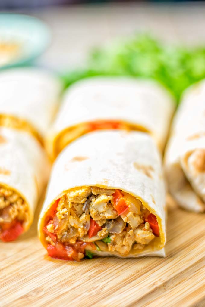 This Vegan Breakfast Burrito with Tofu Scramble is super easy to make and seriously the best burritos you’ve ever made and tasted. No one would guess it’s entirely vegan, gluten free and your family won’t miss the cheese or meat in these. These are also an amazing pick for meal prep, dinner, lunch, work lunch and so much more. #vegan #dairyfree #glutenfree #contentednesscooking #breakfastburritos #tofuscramble #breakfastideas #budgetmeals #dinner #lunch #mealprep #worklunchideas 