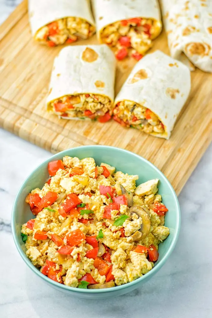 This Vegan Breakfast Burrito with Tofu Scramble is super easy to make and seriously the best burritos you’ve ever made and tasted. No one would guess it’s entirely vegan, gluten free and your family won’t miss the cheese or meat in these. These are also an amazing pick for meal prep, dinner, lunch, work lunch and so much more. #vegan #dairyfree #glutenfree #contentednesscooking #breakfastburritos #tofuscramble #breakfastideas #budgetmeals #dinner #lunch #mealprep #worklunchideas 