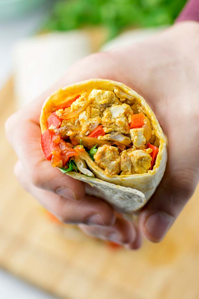 This Vegan Breakfast Burrito with Tofu Scramble is super easy to make and seriously the best burritos you’ve ever made and tasted. No one would guess it’s entirely vegan, gluten free and your family won’t miss the cheese or meat in these. These are also an amazing pick for meal prep, dinner, lunch, work lunch and so much more. #vegan #dairyfree #glutenfree #contentednesscooking #breakfastburritos #tofuscramble #breakfastideas #budgetmeals #dinner #lunch #mealprep #worklunchideas 