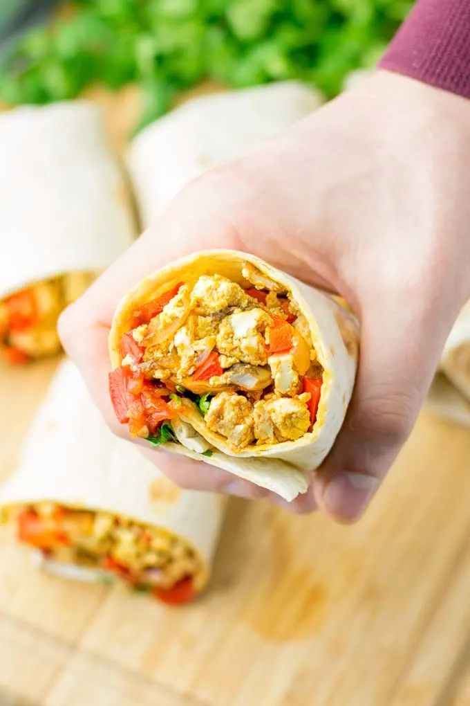 This Vegan Breakfast Burrito with Tofu Scramble is super easy to make and seriously the best burritos you’ve ever made and tasted. No one would guess it’s entirely vegan, gluten free and your family won’t miss the cheese or meat in these. These are also an amazing pick for meal prep, dinner, lunch, work lunch and so much more. #vegan #dairyfree #glutenfree #contentednesscooking #breakfastburritos #tofuscramble #breakfastideas #budgetmeals #dinner #lunch #mealprep #worklunchideas 