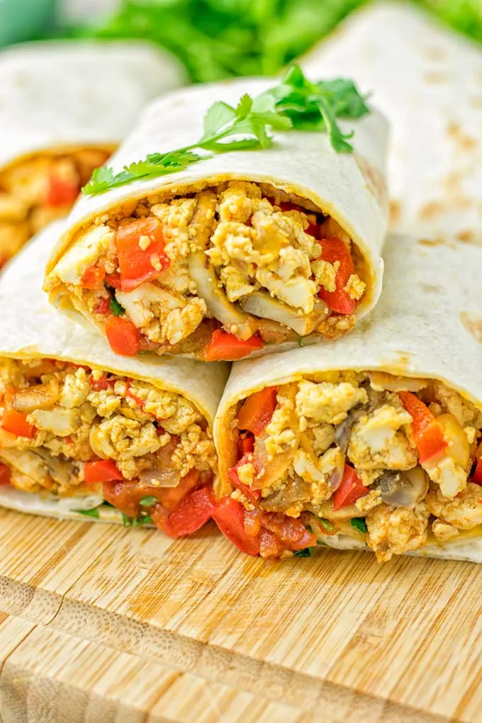 This Vegan Breakfast Burrito with Tofu Scramble is super easy to make and seriously the best burritos you’ve ever made and tasted. No one would guess it’s entirely vegan, gluten free and your family won’t miss the cheese or meat in these. These are also an amazing pick for meal prep, dinner, lunch, work lunch and so much more. #vegan #dairyfree #glutenfree #contentednesscooking #breakfastburritos #tofuscramble #breakfastideas #budgetmeals #dinner #lunch #mealprep #worklunchideas 