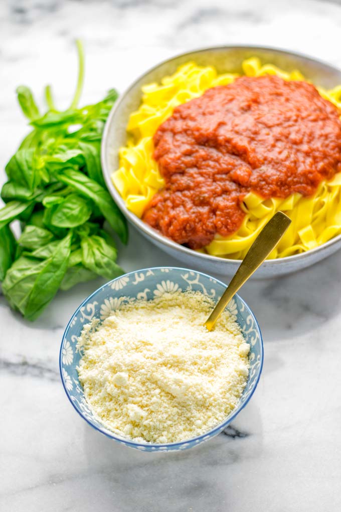 This Vegan Parmesan Cheese is made with super simple 3 ingredients in 1 minute. Trust me you really want this recipe - so versatile for all your pasta, casseroles, salads and so much more. It’s a keeper for lunch, dinner, meal prep, work lunch that the whole family will love. #vegan #dairyfree #glutenfree #dinner #lunch #mealprep #worklunchideas #contentednesscooking #veganparmesancheese #pasta #pizza #casseroles #salads #familyfoodideas