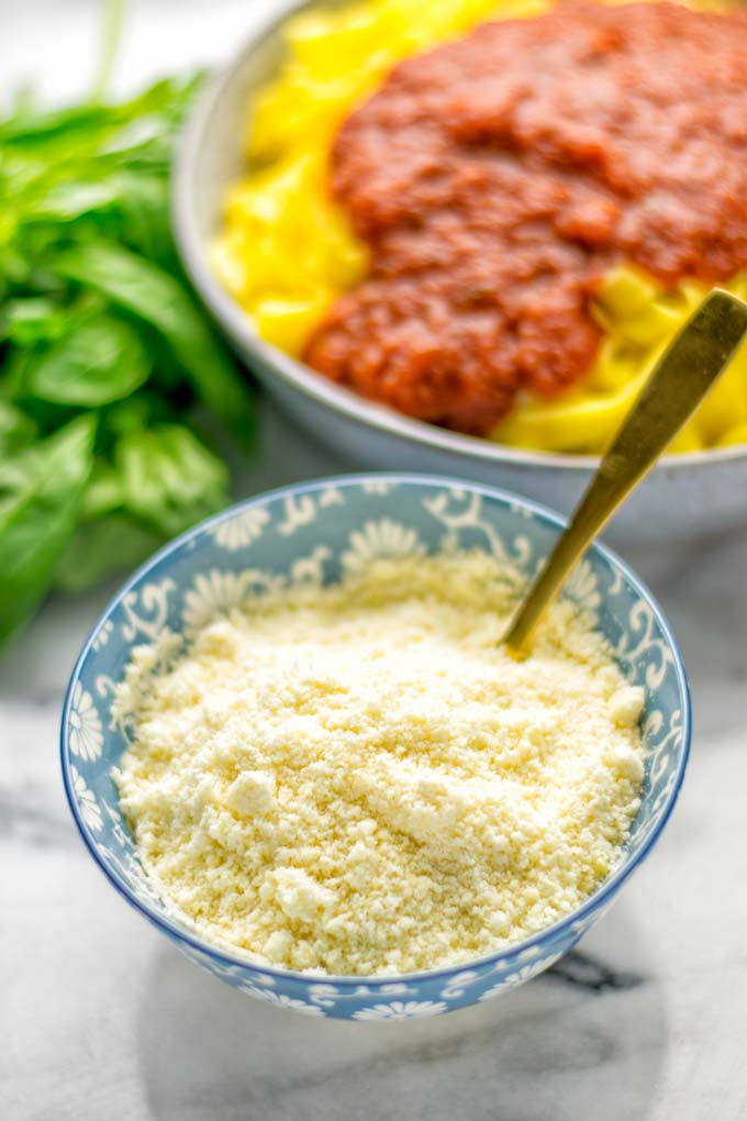 This Vegan Parmesan Cheese is made with super simple 3 ingredients in 1 minute. Trust me you really want this recipe - so versatile for all your pasta, casseroles, salads and so much more. It’s a keeper for lunch, dinner, meal prep, work lunch that the whole family will love. #vegan #dairyfree #glutenfree #dinner #lunch #mealprep #worklunchideas #contentednesscooking #veganparmesancheese #pasta #pizza #casseroles #salads #familyfoodideas