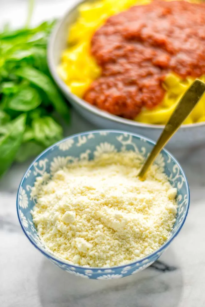 This Vegan Parmesan Cheese is made with super simple 3 ingredients in 1 minute. Trust me you really want this recipe - so versatile for all your pasta, casseroles, salads and so much more. It’s a keeper for lunch, dinner, meal prep, work lunch that the whole family will love. #vegan #dairyfree #glutenfree #dinner #lunch #mealprep #worklunchideas #contentednesscooking #veganparmesancheese #pasta #pizza #casseroles #salads #familyfoodideas