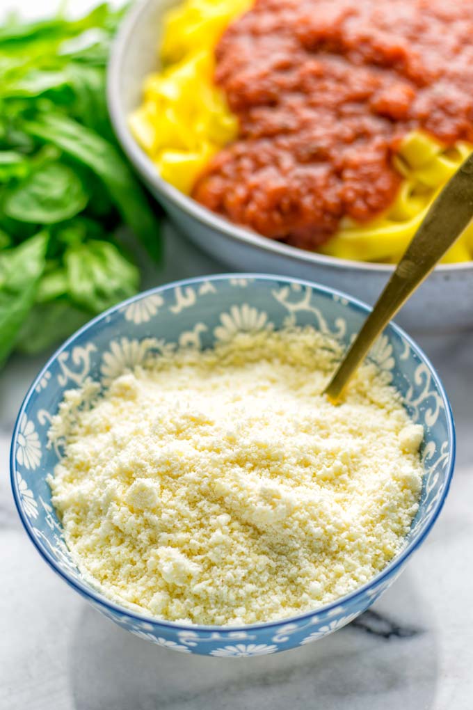 This Vegan Parmesan Cheese is made with super simple 3 ingredients in 1 minute. Trust me you really want this recipe - so versatile for all your pasta, casseroles, salads and so much more. It’s a keeper for lunch, dinner, meal prep, work lunch that the whole family will love. #vegan #dairyfree #glutenfree #dinner #lunch #mealprep #worklunchideas #contentednesscooking #veganparmesancheese #pasta #pizza #casseroles #salads #familyfoodideas