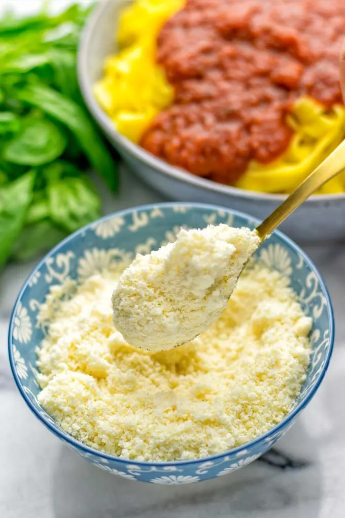 This Vegan Parmesan Cheese is made with super simple 3 ingredients in 1 minute. Trust me you really want this recipe - so versatile for all your pasta, casseroles, salads and so much more. It’s a keeper for lunch, dinner, meal prep, work lunch that the whole family will love. #vegan #dairyfree #glutenfree #dinner #lunch #mealprep #worklunchideas #contentednesscooking #veganparmesancheese #pasta #pizza #casseroles #salads #familyfoodideas