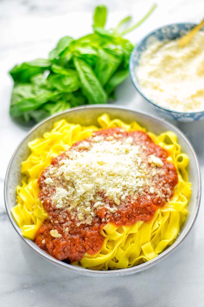 This Vegan Parmesan Cheese is made with super simple 3 ingredients in 1 minute. Trust me you really want this recipe - so versatile for all your pasta, casseroles, salads and so much more. It’s a keeper for lunch, dinner, meal prep, work lunch that the whole family will love. #vegan #dairyfree #glutenfree #dinner #lunch #mealprep #worklunchideas #contentednesscooking #veganparmesancheese #pasta #pizza #casseroles #salads #familyfoodideas