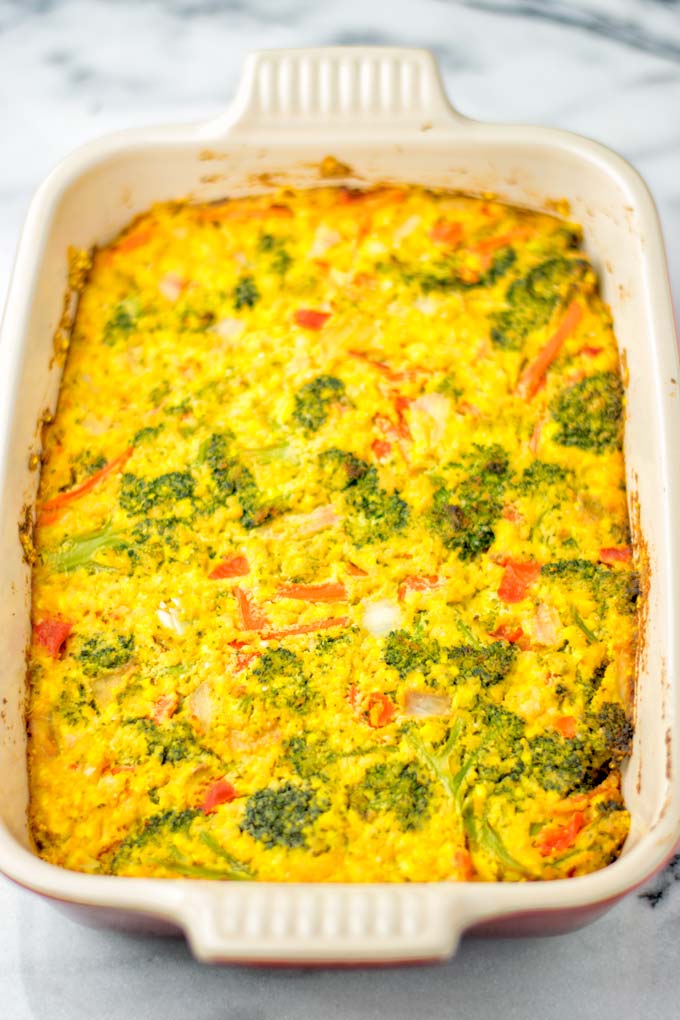 View from above on the crustless quiche in a red casserole coming fresh out of the oven.