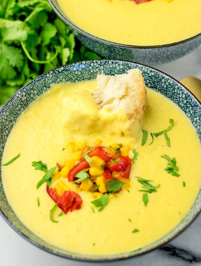 Portion of the corn chowder made in the instant pot with a piece of fresh bread.