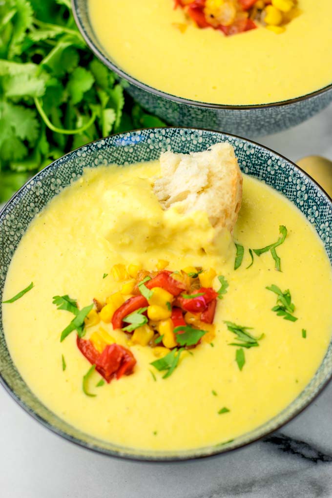 Portion of the corn chowder made in the instant pot with a piece of fresh bread.