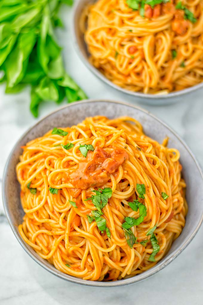 instant pot spaghetti recipe topped with fresh basil