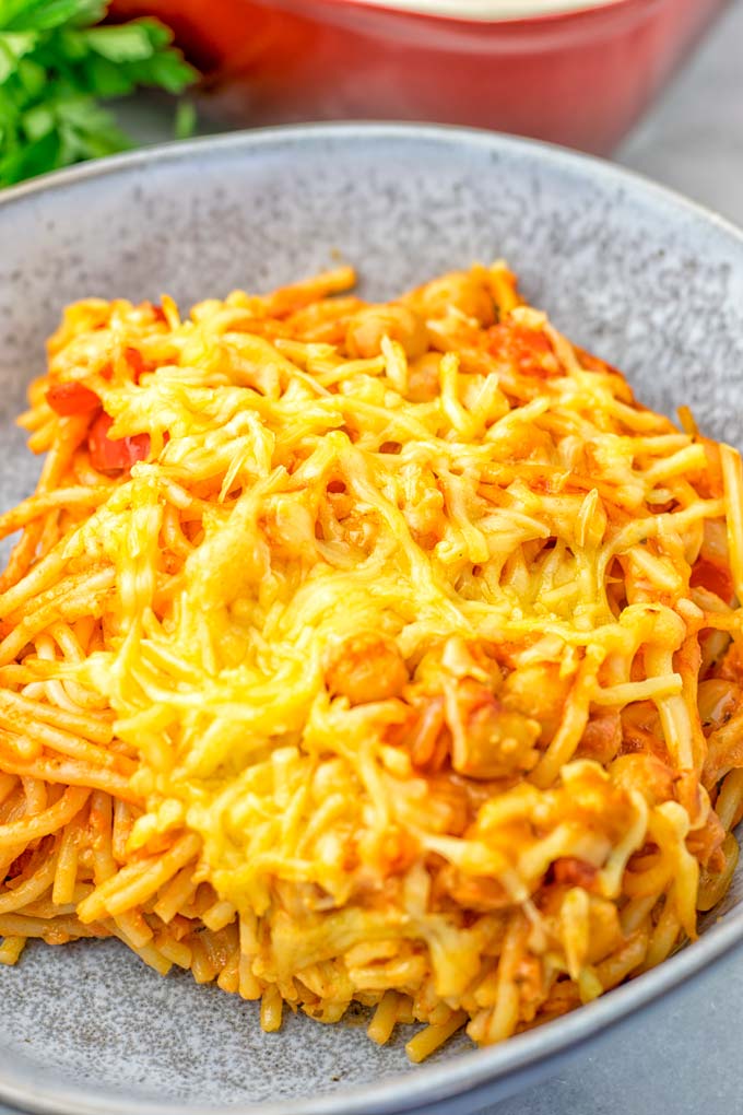 Portion of the spaghetti casserole served in a light blue bowl.