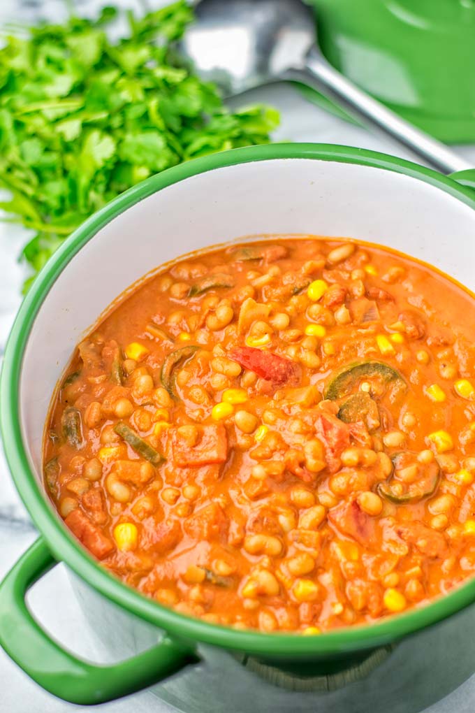 Ingredients of the vegetarian white bean chili visible in pot.