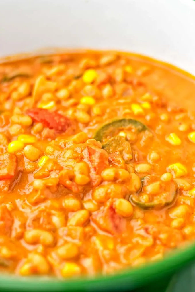 Closeup to white beans and jalapeno in a pot.