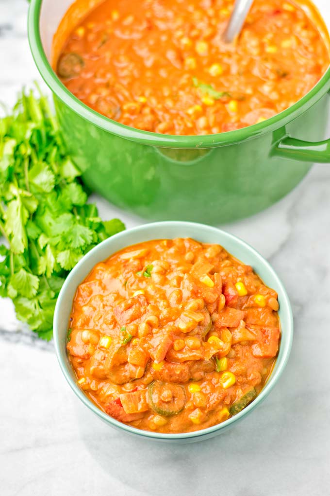 Portion of Vegetarian White Bean Chili served in a bowl with the pot in the background.