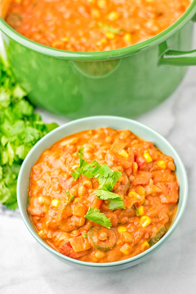 Bowl with the white bean chili decorated with cilantro.