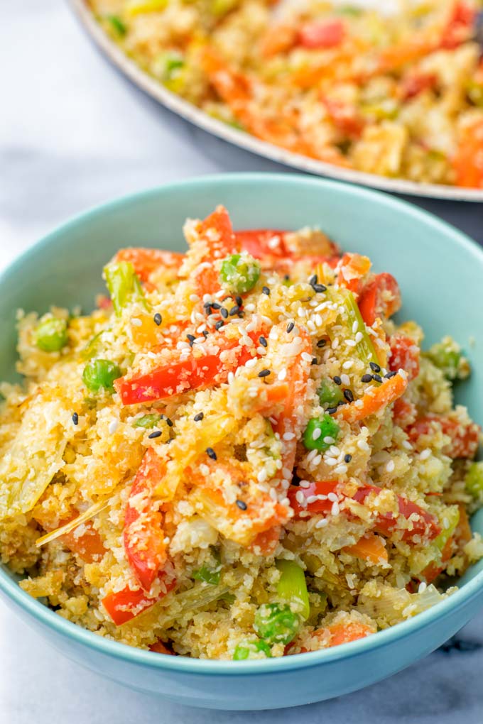 Portion of Cauliflower Fried Rice in a light blue bowl. 