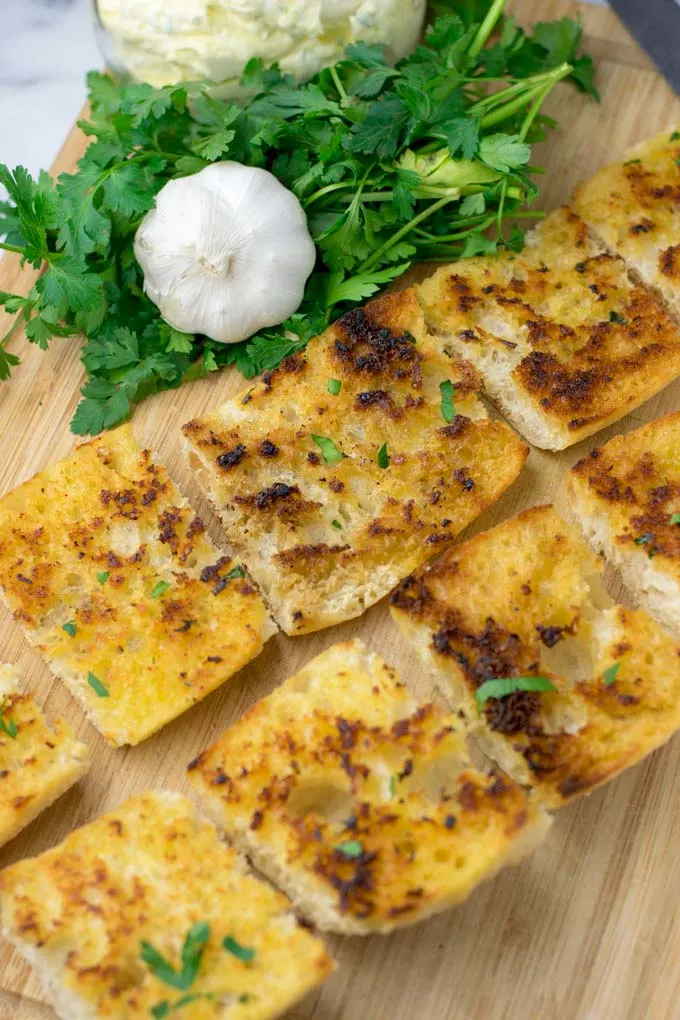 Sprinkling parse;y over the Garlic Bread.