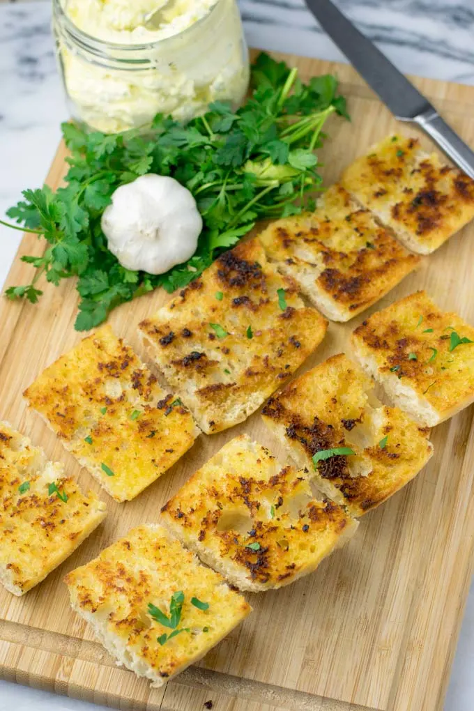 Top view of a plate with slices of Garlic Bread.