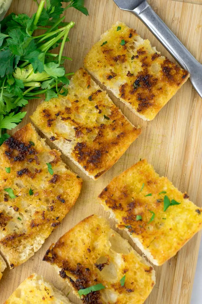 Top view of a plate with slices of Garlic Bread.