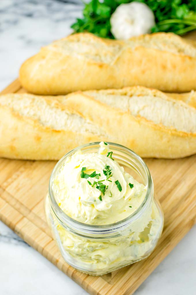 Butter jar, two baguette breads in the background.