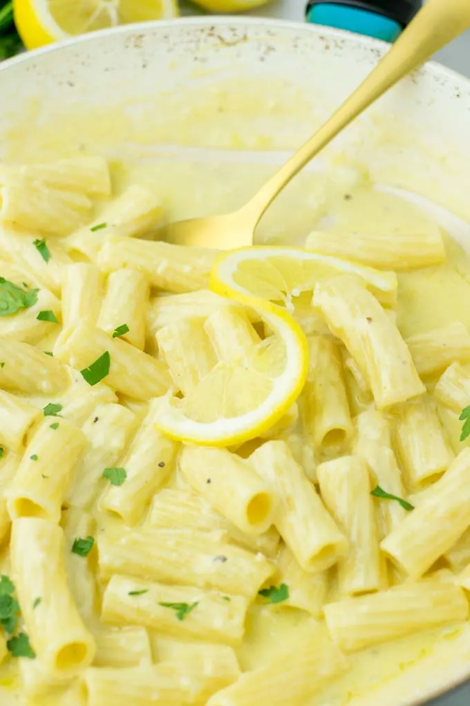 Portion of pasta in a saucepan, decorated with parsley.