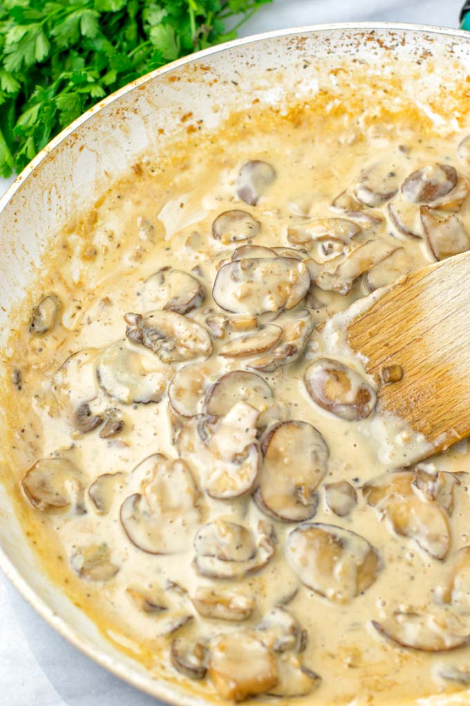 Marsala Sauce cooking in the saucepan, showing mushrooms being sauteed in a creamy sauce.