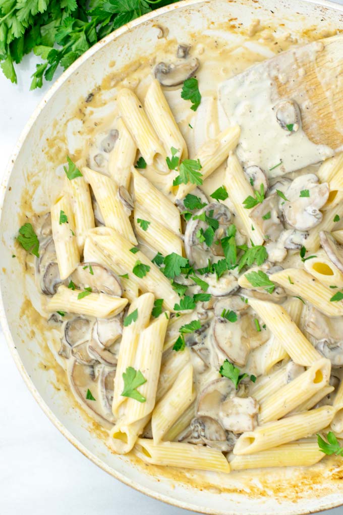 Parsley covered portion of pasta.