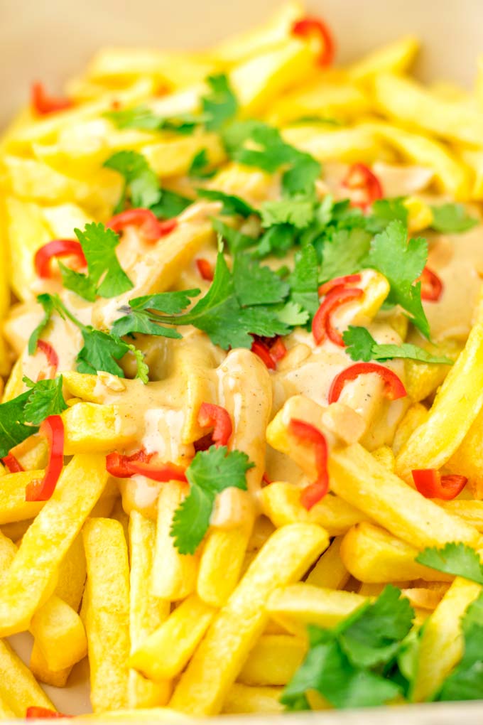 Oven fries with satay sauce, sprinkled with cilantro and chilies. 