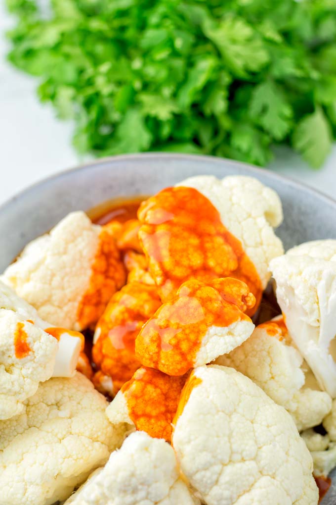 Buffalo Cauliflower drenched, ready to go into the oven.