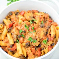 Top view of a family meal of Cajun Pasta, sprinkled with parsley.