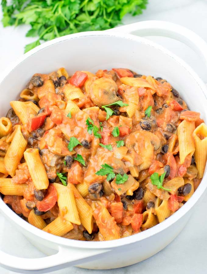 Top view of a family meal of Cajun Pasta, sprinkled with parsley.