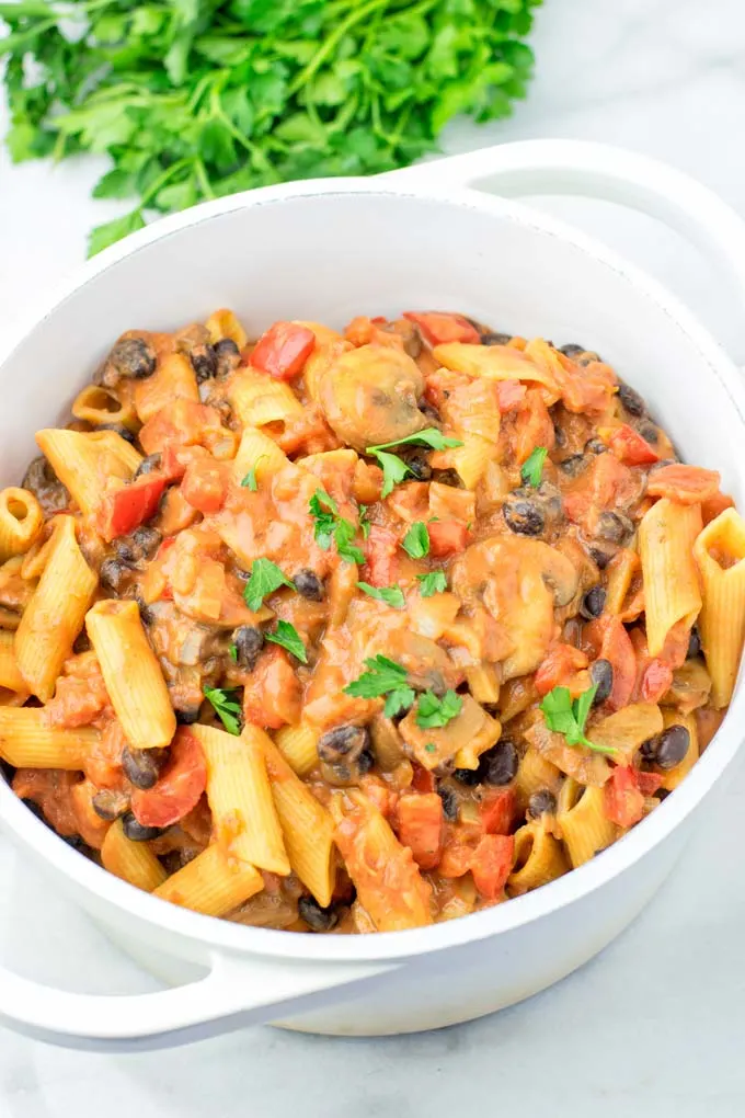 Top view of a family meal of Cajun Pasta, sprinkled with parsley.