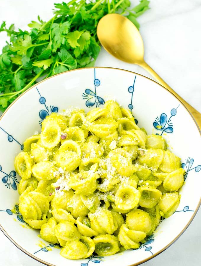 Pesto pasta sprinkled with fresh vegan Parmesan.