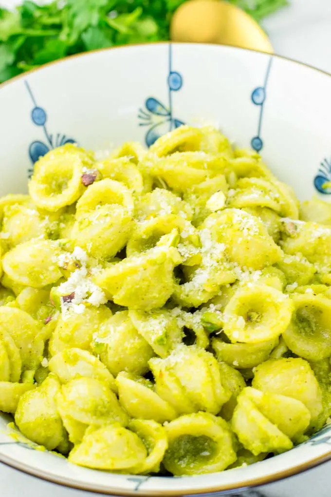 Closeup of Parmesan covered pistachio pesto pasta.