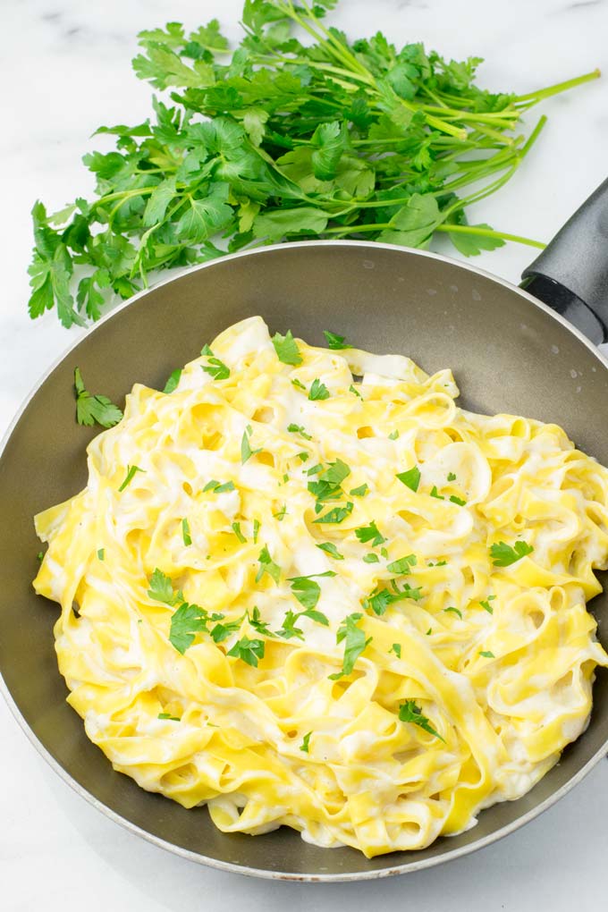 Parsley is sprinkled over the white wine sauce.