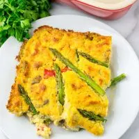 Portion of the Asparagus Quiche on a white plate.