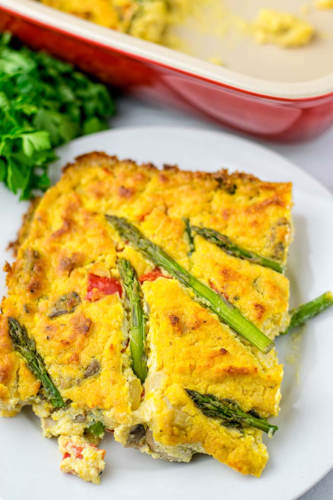 Closeup view showing the golden brown baked tofu filling, bell pepper, asparagus tips, and mushrooms.