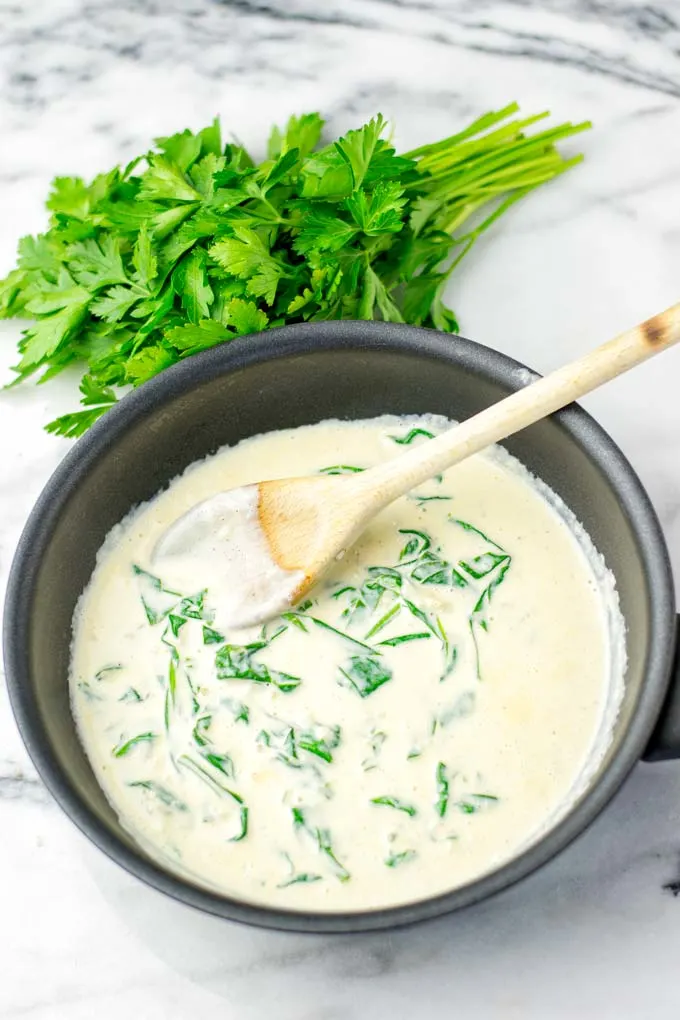 Fresh spinach seen cooking in the Florentine sauce.