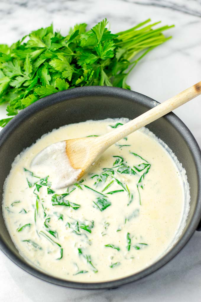 Fresh spinach seen cooking in the Florentine sauce.