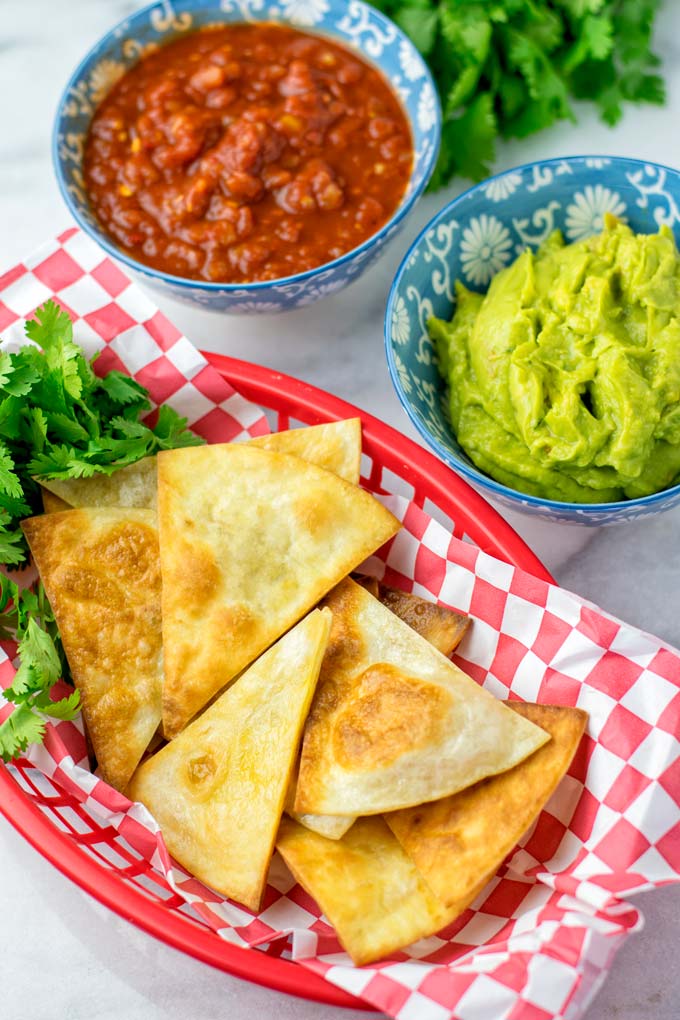 Tortilla chips in a red basket.