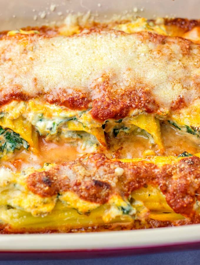 Closeup of the filled Manicotti, covered with vegan Parmesan and baked to perfection.