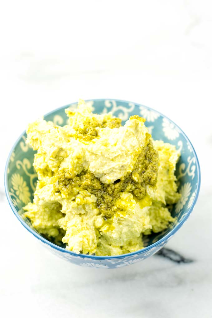 Close view of the pesto butter in a blue bowl.