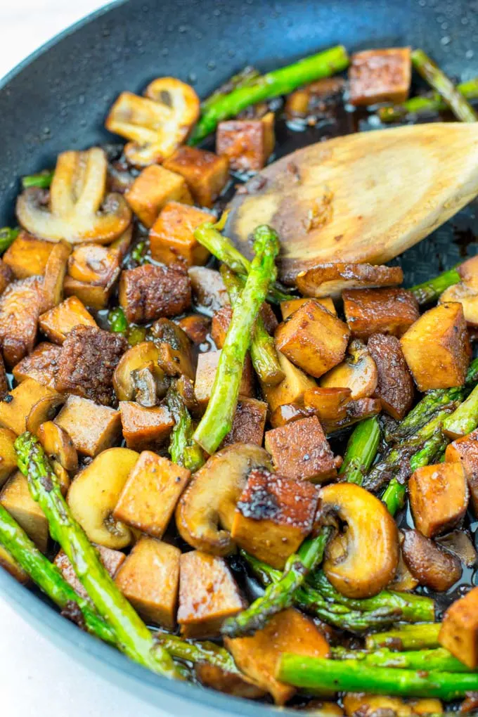 The Asparagus Stir Fry is made with tofu and mushrooms.