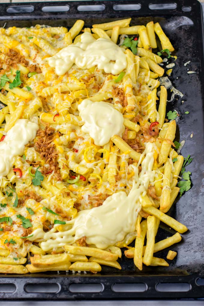 Single sheet pan for the oven, filled with loaded fries.