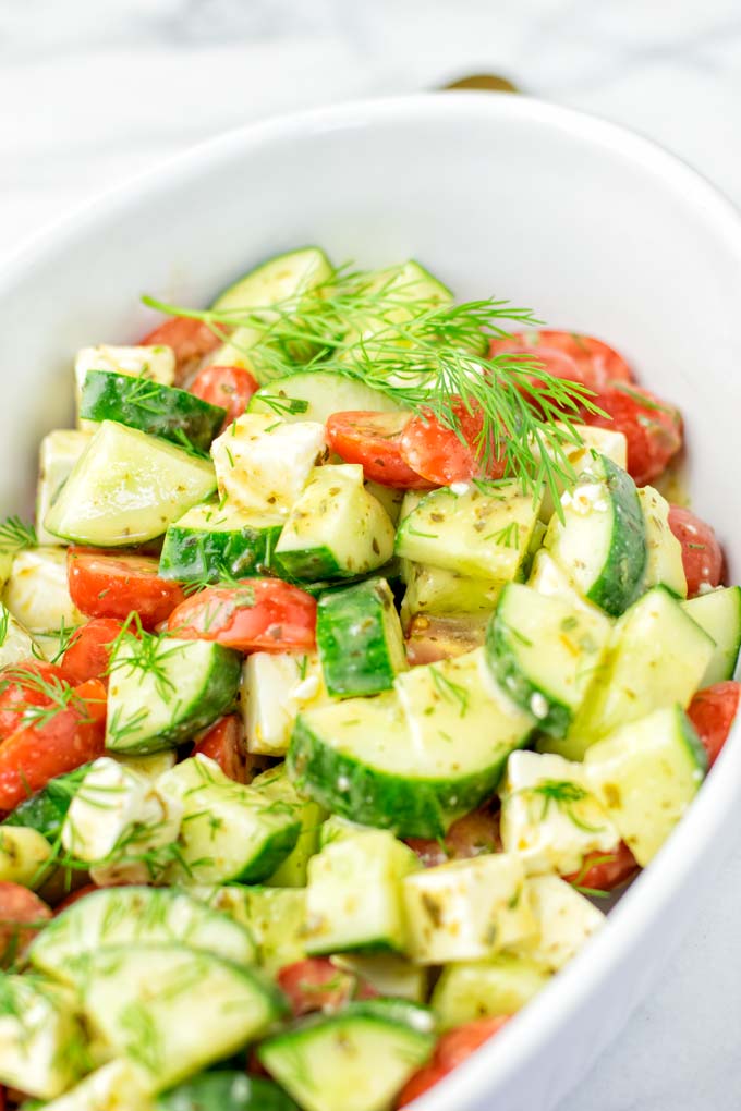 Cucumber and Tomato Salad served in a white bowl.